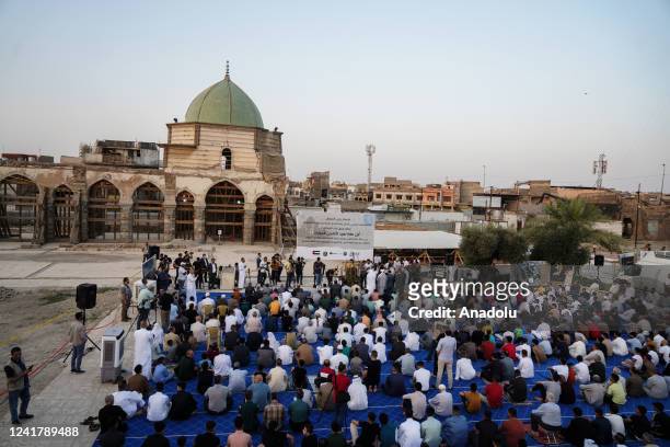 Muslims arrive to perform Eid al-Adha prayer among the ruins of the city's oldest mosque, The Great Mosque of al-Nuri which was detonated by Daesh in...