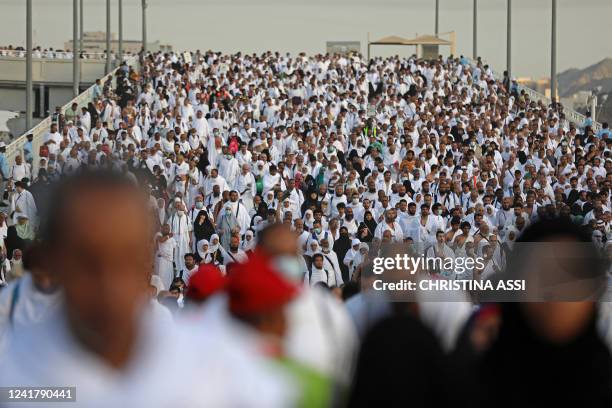 Thousands of Muslim pilgrims make their way across the valley of Mina, near Mecca in western Saudi Arabia, to perform the "stoning of the devil"...
