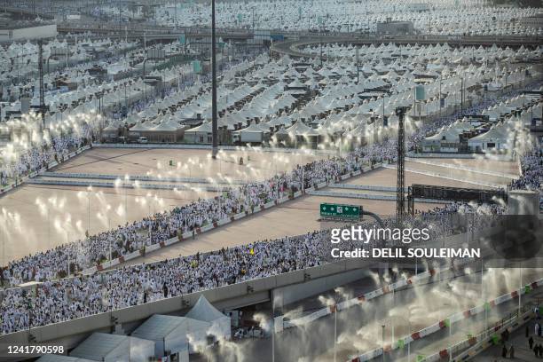 Thousands of Muslim pilgrims make their way across the valley of Mina, near Mecca in western Saudi Arabia, to perform the "stoning of the devil"...