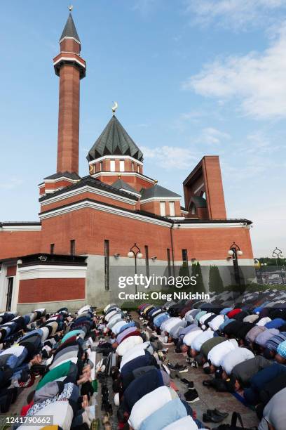 Muslim men attend a morning prayer to mark Eid al-Adha festival of sacrifice holiday outside Memorial Mosque on Poklonnaya Hill on July 9, 2022 in...