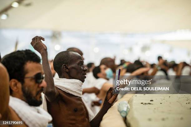 Muslim pilgrims perform the "stoning of the devil" ritual which marks the start of the Eid al-Adha holiday in the valley of Mina, near the holy city...