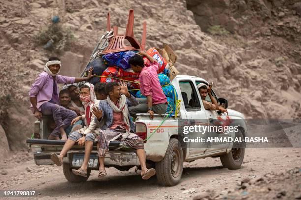 This picture taken in the mountains near Yemen's third-largest city of Taez, shows an overloaded vehicle driving through a damaged narrow road that...