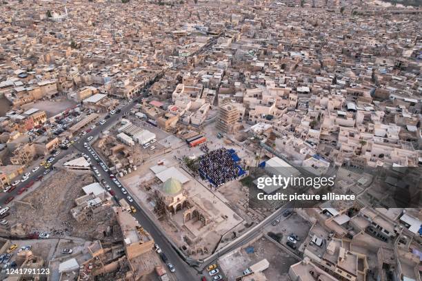 July 2022, Iraq, Mosul: Muslims perform prayers of Eid al-Adha, the holiest feast in Islam, at the courtyard of the Great Mosque of al-Nuri, which...