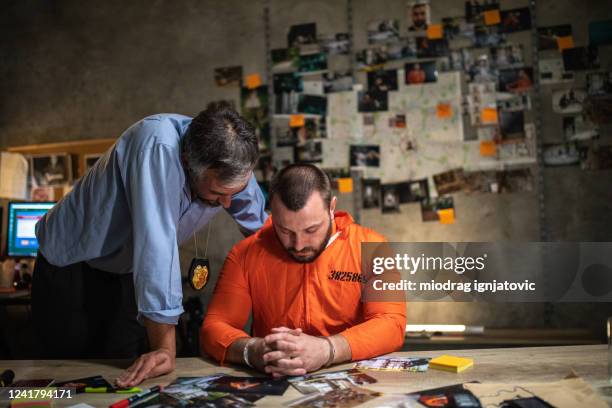 fbi director talking with prisoner about ongoing investigation late at night at office - fbi director stock pictures, royalty-free photos & images