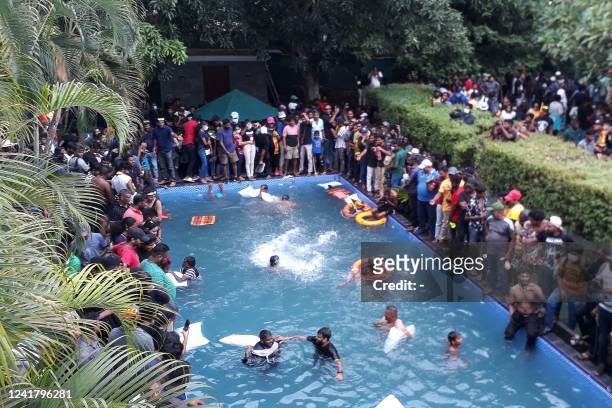 Protestors demanding the resignation of Sri Lanka's President Gotabaya Rajapaksa swim in a pool inside the compound of Sri Lanka's Presidential...