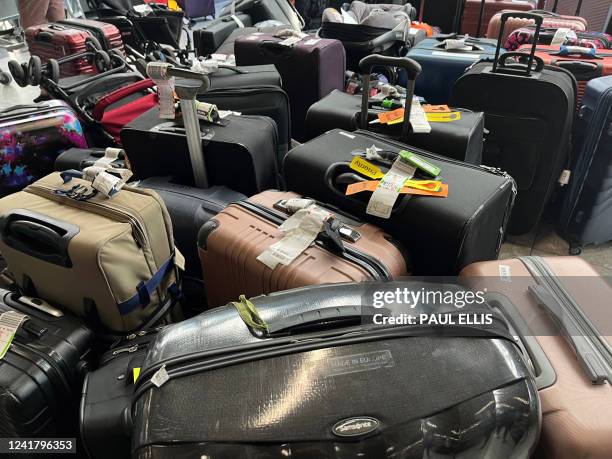Suitcases are seen uncollected at Heathrow's Terminal Three bagage reclaim, west of London on July 8, 2022. British Airways on Wednesday axed another...