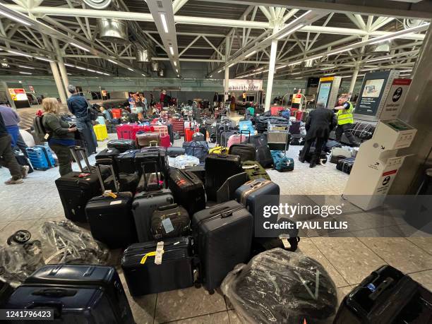 Suitcases are seen uncollected at Heathrow's Terminal Three bagage reclaim, west of London on July 8, 2022. British Airways on Wednesday axed another...