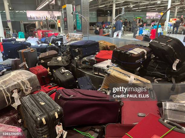 Suitcases are seen uncollected at Heathrow's Terminal Three bagage reclaim, west of London on July 8, 2022. British Airways on Wednesday axed another...
