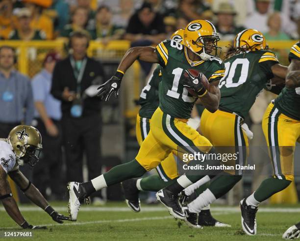 Randall Cobb of the Green Bay Packers returns a kick-off for a touchdown against the New Orleans Saints during the NFL opening season game at Lambeau...