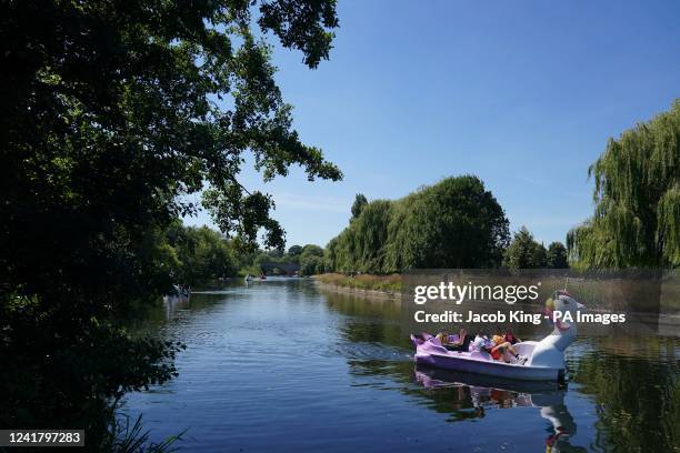 Family pilot a unicorn-themed pedalo on the river Avon in Warwick. Picture date: Saturday July 9, 2022.