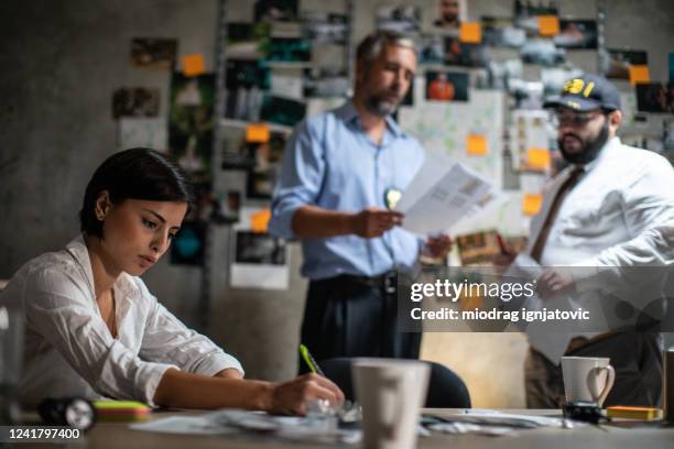 fbi detectives looking for a clues during crime investigation late at night at office - fbi director stock pictures, royalty-free photos & images