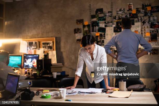 夜遅くにオフィスで働く女性探偵 - police station ストックフォトと画像