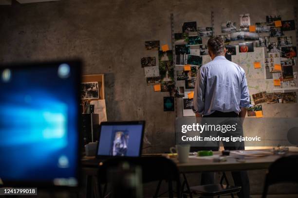 police chef working late at night at office - fbi stock pictures, royalty-free photos & images