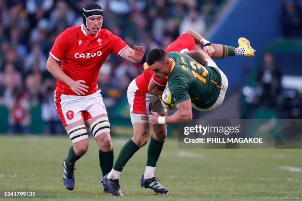 South Africa's center Jesse Kriel reacts while being tackled by Wales' full-back Liam Williams during an international rugby union match between...