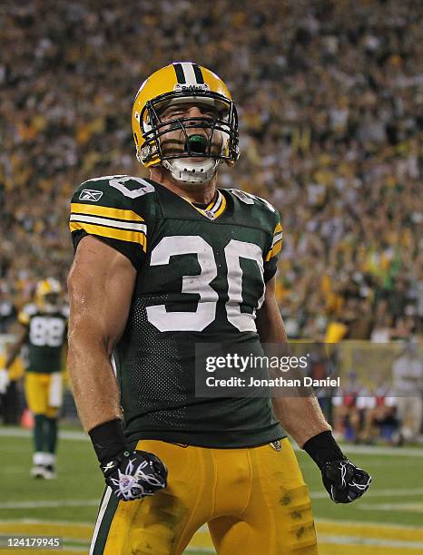 John Kuhn of the Green Bay Packers celebrates after scoring a touchdown against the New Orleans Saints during the NFL opening season game at Lambeau...