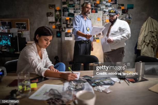 fbi detectives looking for a clues during crime investigation late at night at office - fbi director stock pictures, royalty-free photos & images