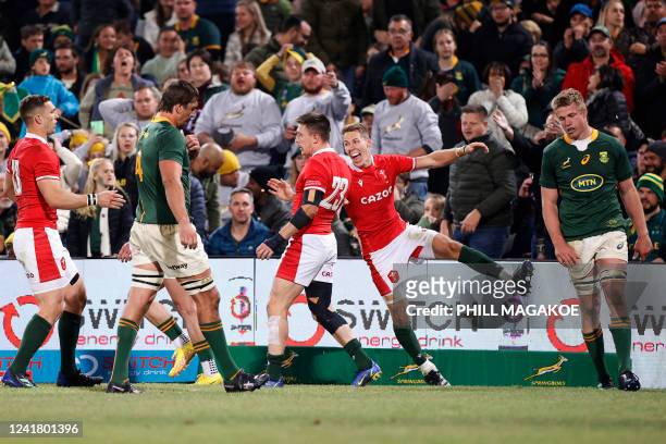 Wales' full-back Liam Williams congratulates Wales' Josh Adams after scoring a try as South Africa's flanker Pieter-Steph du Toit and South Africa's...