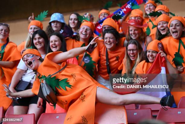 Dutch fans pose for a photograph as they await kick off inside the stadium ahead of the UEFA Women's Euro 2022 Group C football match between...