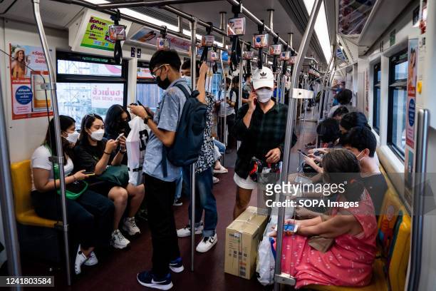 Passengers wearing face masks on the BTS Skytrain during evening rush hours.
