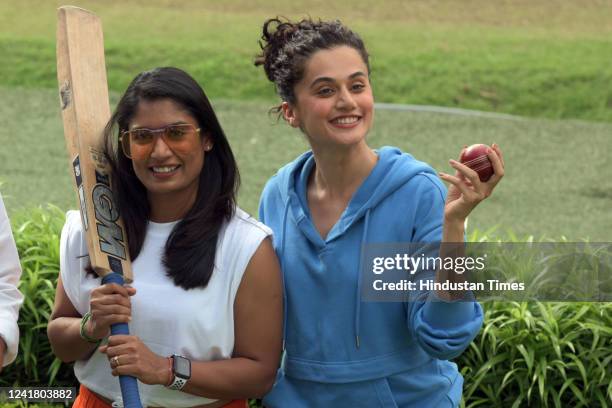 Former Indian women's cricket team captain Mithali Raj and Bollywood actor Taapsee Pannu pose for pictures during a promotional event of the upcoming...