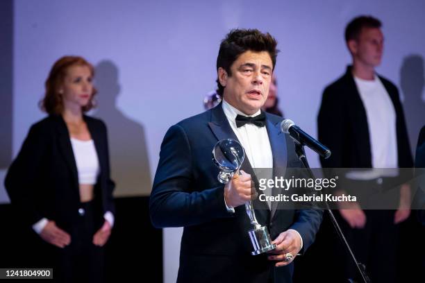 Benicio del Toro delivers a speech after receiving the Crystal Globe for the Festival President's Award during the closing ceremony of the 56th...