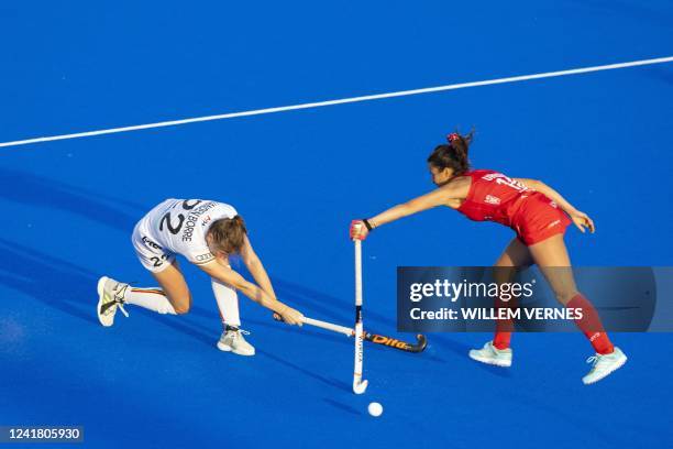 Belgium's Stephanie Vanden Borre and Chile's Manuela Urroz vie during the women's FIH World Cup field hockey match between Belgium and Chile at the...