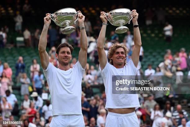 Australia's Matthew Ebden and Australia's Max Purcell celebrate with the trophy during the podium ceremony after winning against Croatia's Nikola...