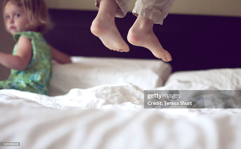 Jumping on bed with feet in middair