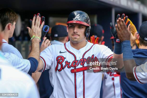 Austin Riley of the Atlanta Braves celebrates with teammates after a two-run home run against the Washington Nationals in the first inning at Truist...