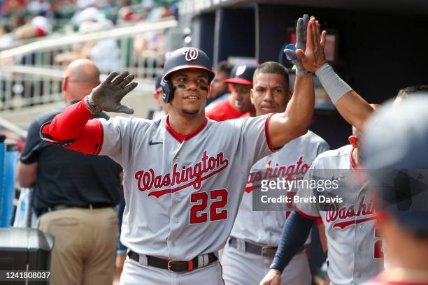 Juan Soto of the Washington Nationals celebrates with teammates after a home run against the Atlanta Braves in the third inning at Truist Park on...