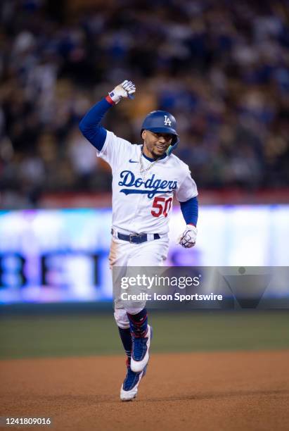 Los Angeles Dodgers right fielder Mookie Betts runs toward third after hitting a home run against Chicago Cubs relief pitcher Scott Effross at Dodger...