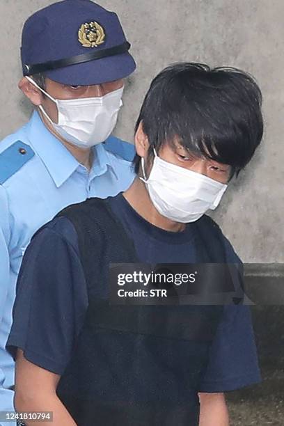 Tetsuya Yamagami , the man accused of murdering former Japanese Prime Minister Shinzo Abe, is escorted by police while leaving the Nara Nishi police...