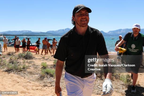 Hockey player T.J. Oshie swings from the lakeside beach on the 18th hole during Round Two of the 2022 American Century Championship at Edgewood Tahoe...