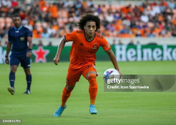 Houston Dynamo midfielder Adalberto Carrasquilla attempts to keep the ball in the field in the first half during the MLS match between FC Dallas and...