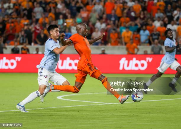 Houston Dynamo midfielder Fafà Picault beats FC Dallas defender Marco Farfan to the ball in the second half during the MLS match between FC Dallas...