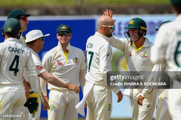 Australia's Nathan Lyon celebrates with teammates after taking wicket of Sri Lanka's Kusal Mendis during the third day of the second cricket Test...