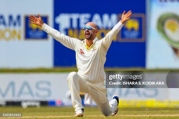 Australia's Nathan Lyon celebrates after taking wicket of Sri Lanka's Kusal Mendis during the third day of the second cricket Test match between Sri...