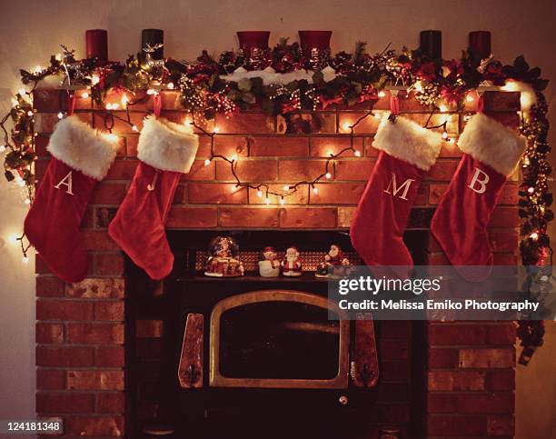 christmas fireplace with stockings - christmas stocking stock pictures, royalty-free photos & images