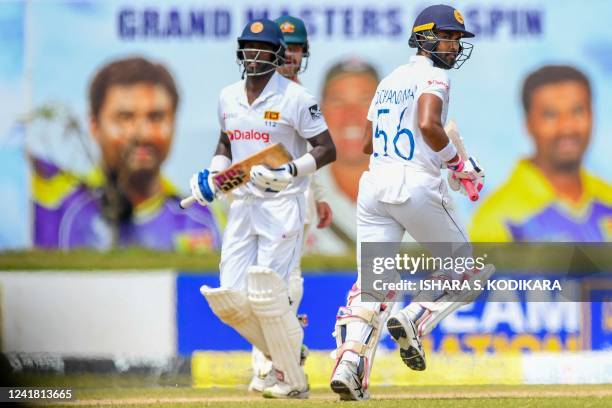 Sri Lanka's Angelo Mathews and Dinesh Chandimal run between the wickets during the third day of the second cricket Test match between Sri Lanka and...