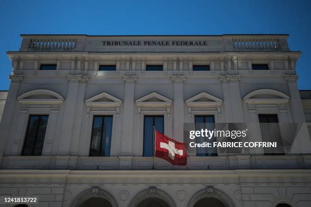 Swiss flag floats in the front of Switzerland's Federal Criminal Court in the southern Switzerland city of Bellinzona, on July 8, 2022. - Sepp...