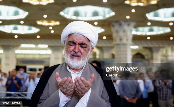 An Iranian cleric takes part in the morning prayer ceremony for Eid al-Adha, celebrated by Muslims worldwide, at Tehran's Imam Khomeini Mosalla...