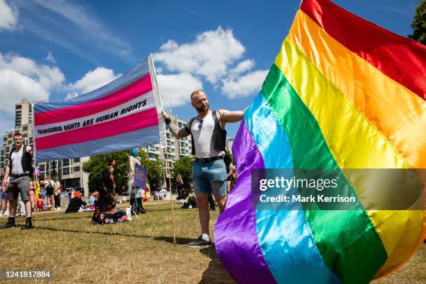 Protesters with a banner and Rainbow Pride flag assemble to take part in a London Trans+ Pride march from the Wellington Arch to Soho on 9th July...