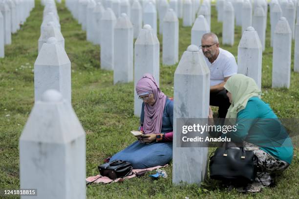 People, who lost their relatives in the 1995 Srebrenica genocide, mourn and pray at the SrebrenicaâPotocari Memorial, in Srebrenica, Bosnia and...