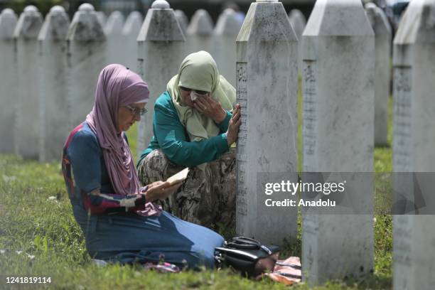 People, who lost their relatives in the 1995 Srebrenica genocide, mourn and pray at the SrebrenicaâPotocari Memorial, in Srebrenica, Bosnia and...