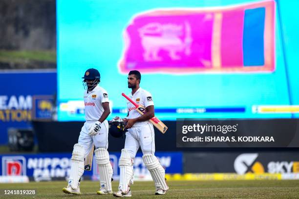 Sri Lanka's Dinesh Chandimal and Ramesh Mendis walk back to the pavilion at the end of the third day play of the second cricket Test match between...