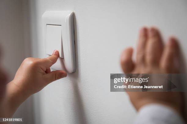 baby pressing down a switch, montargis, france. - turn off light stock pictures, royalty-free photos & images