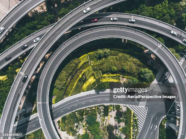 drone view of road intersection - circular business district stock-fotos und bilder