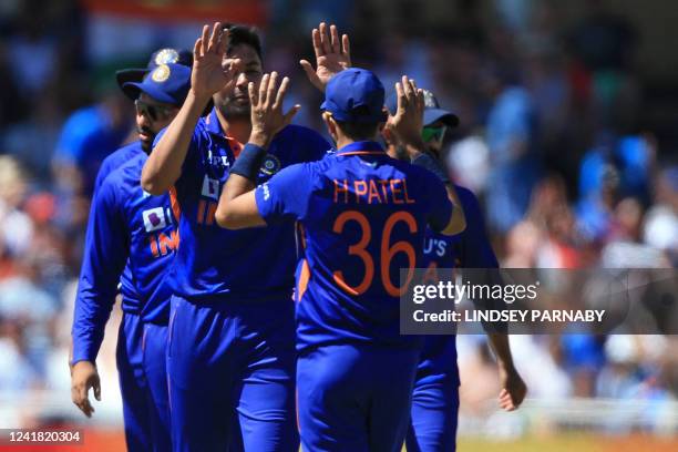 India's Avesh Khan celebrates with teammates after bowling England's Jos Buttler during the '3rd Vitality IT20' Twenty20 International cricket match...