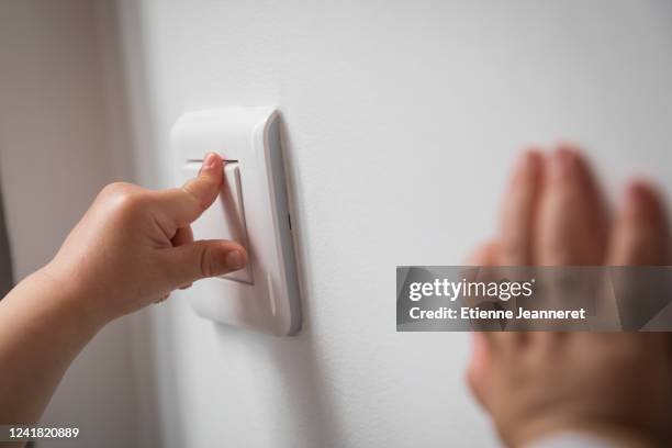 baby pressing up a switch, montargis, france. - turning on or off stock pictures, royalty-free photos & images
