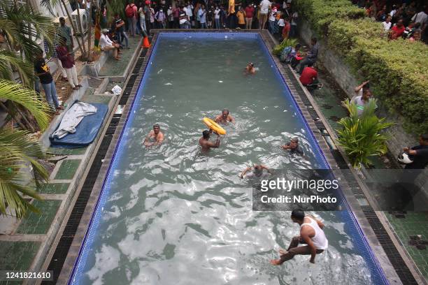 People swim at a swimming pool inside the official residence of the President of Sri Lanka on July 10 the day after demonstrators entered the...